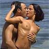 two people nude at the beach kissing
